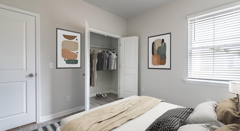 a bedroom with a bed and a closet