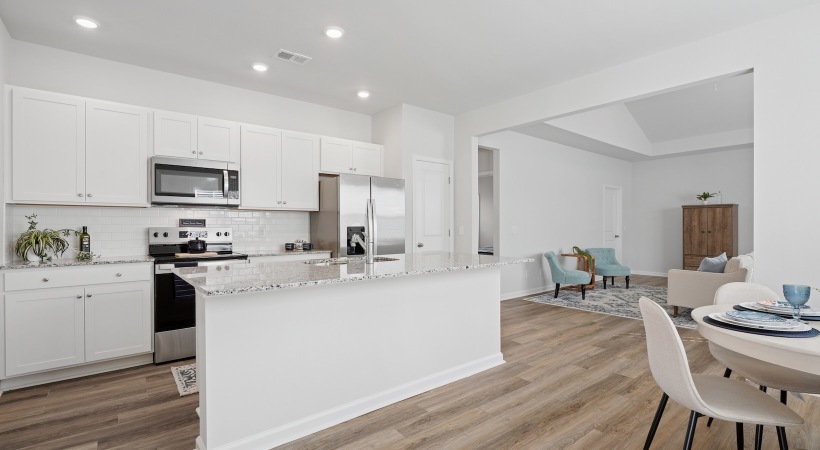 kitchen with an island and dining area with a round table and chairs 