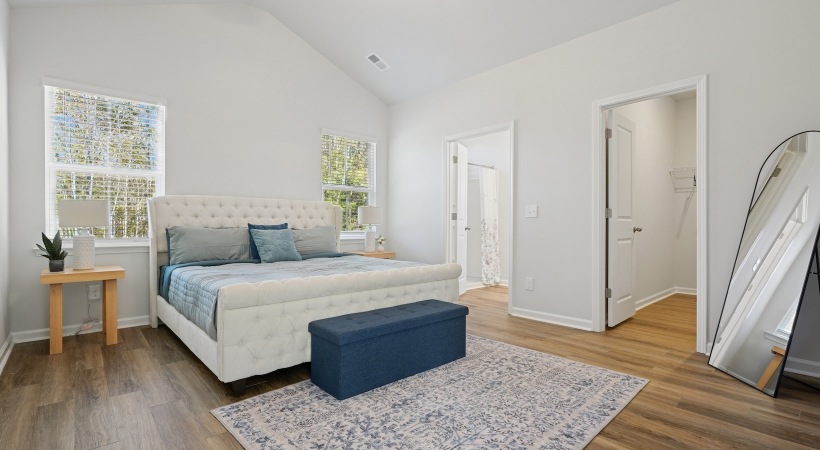bedroom with night stands, a large window and a mirror